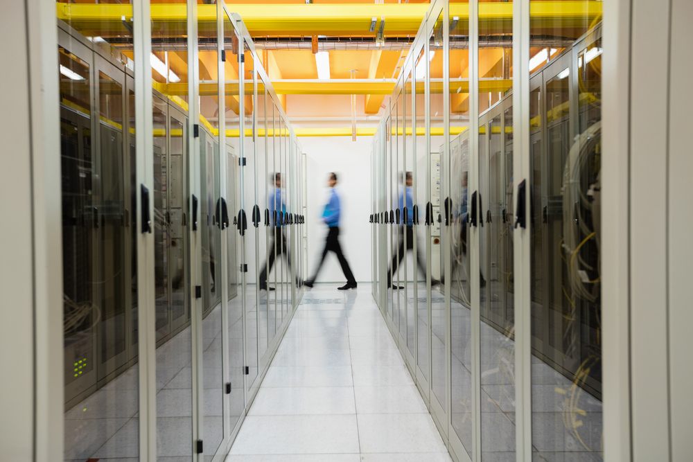man walking through server room IT